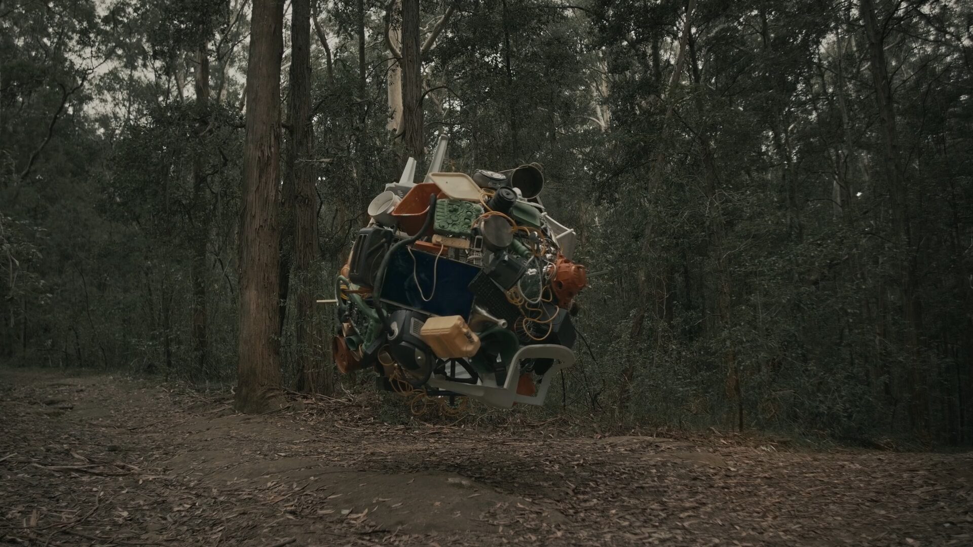 A scene from Goodbye Industrialist. Hello Circulist., showing discarded household objects gathered in a forest
